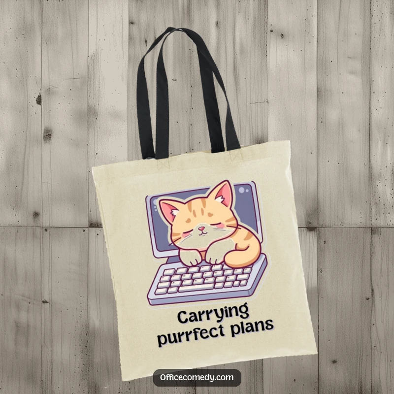 Funny tote bag showing a cat napping on a computer keyboard, ideal for carrying essentials with feline grace.